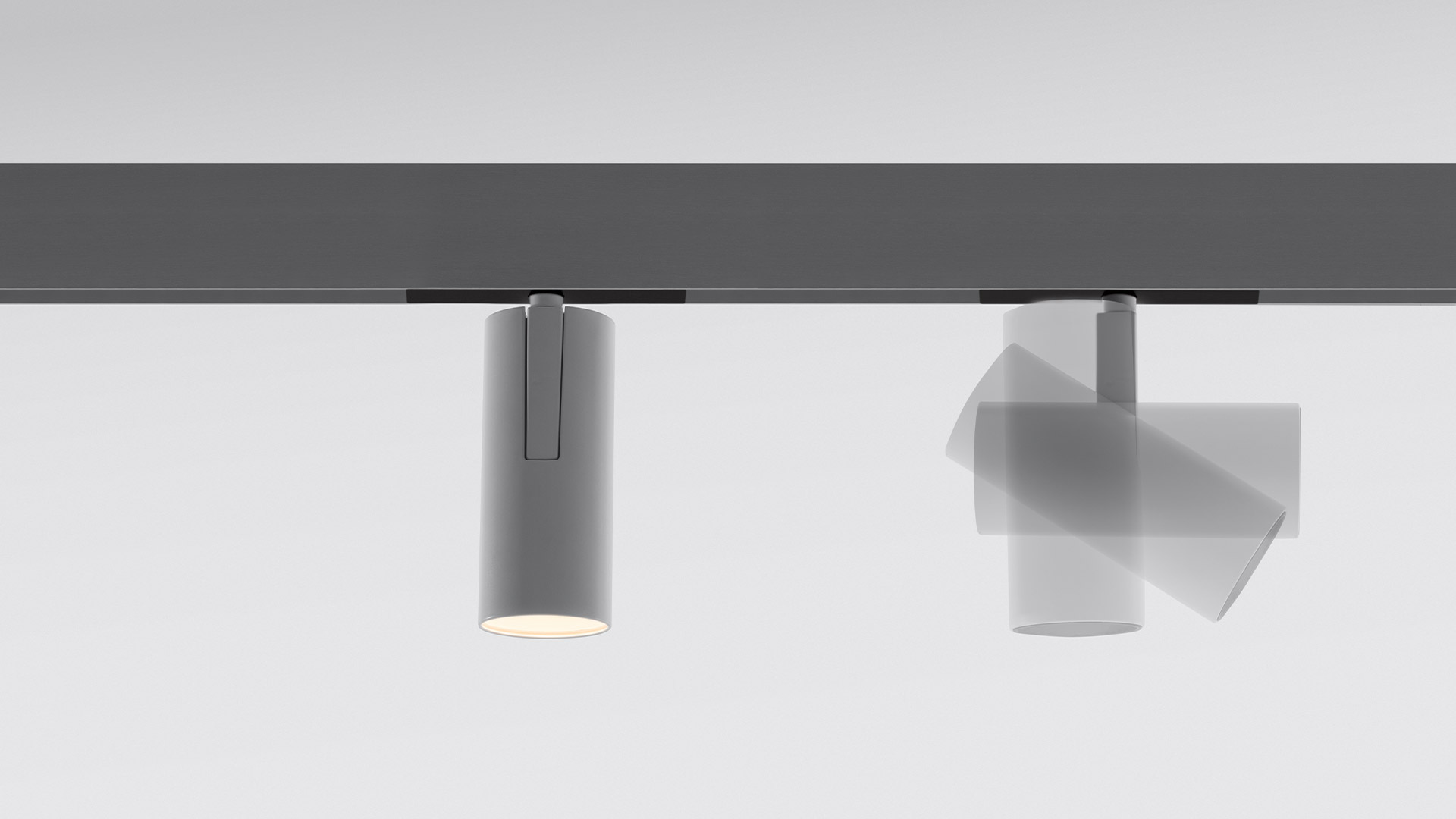 Two Artemide Vector Magnetic track spotlights in grey: left fixed cylindrical, right shown rotating to demonstrate full orientation range