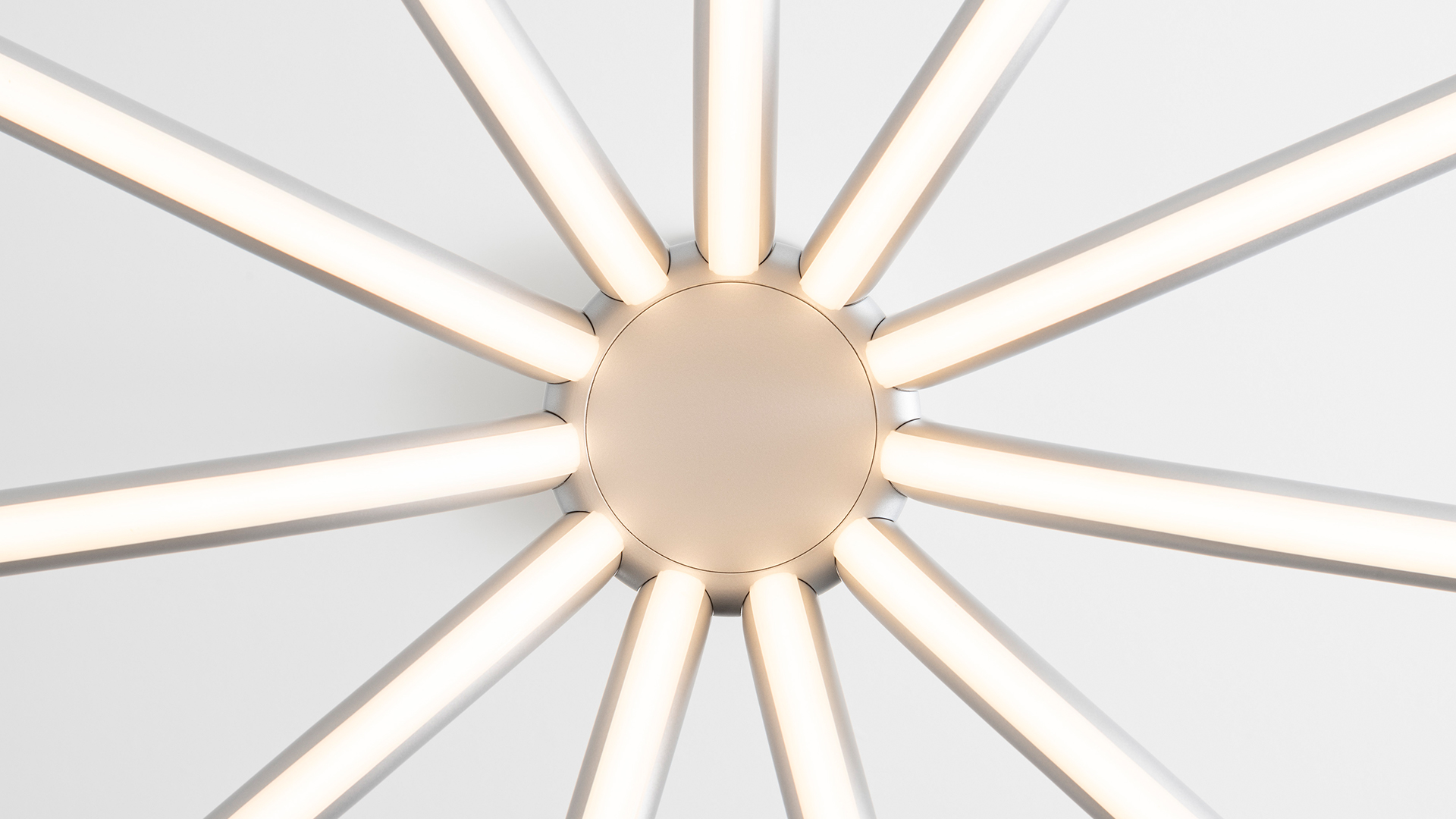 Two Artemide Veil table lamps with slender aluminum stems, horizontal LED bars, and cylindrical brushed metal bases on white surface