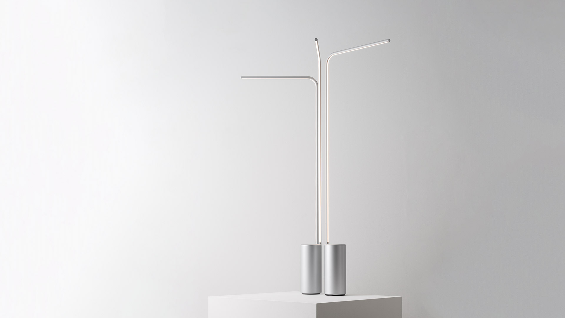 Artemide Veil ceiling lamp, top view: radial LED tubes extending from a central gold disc, creating a sunburst pattern